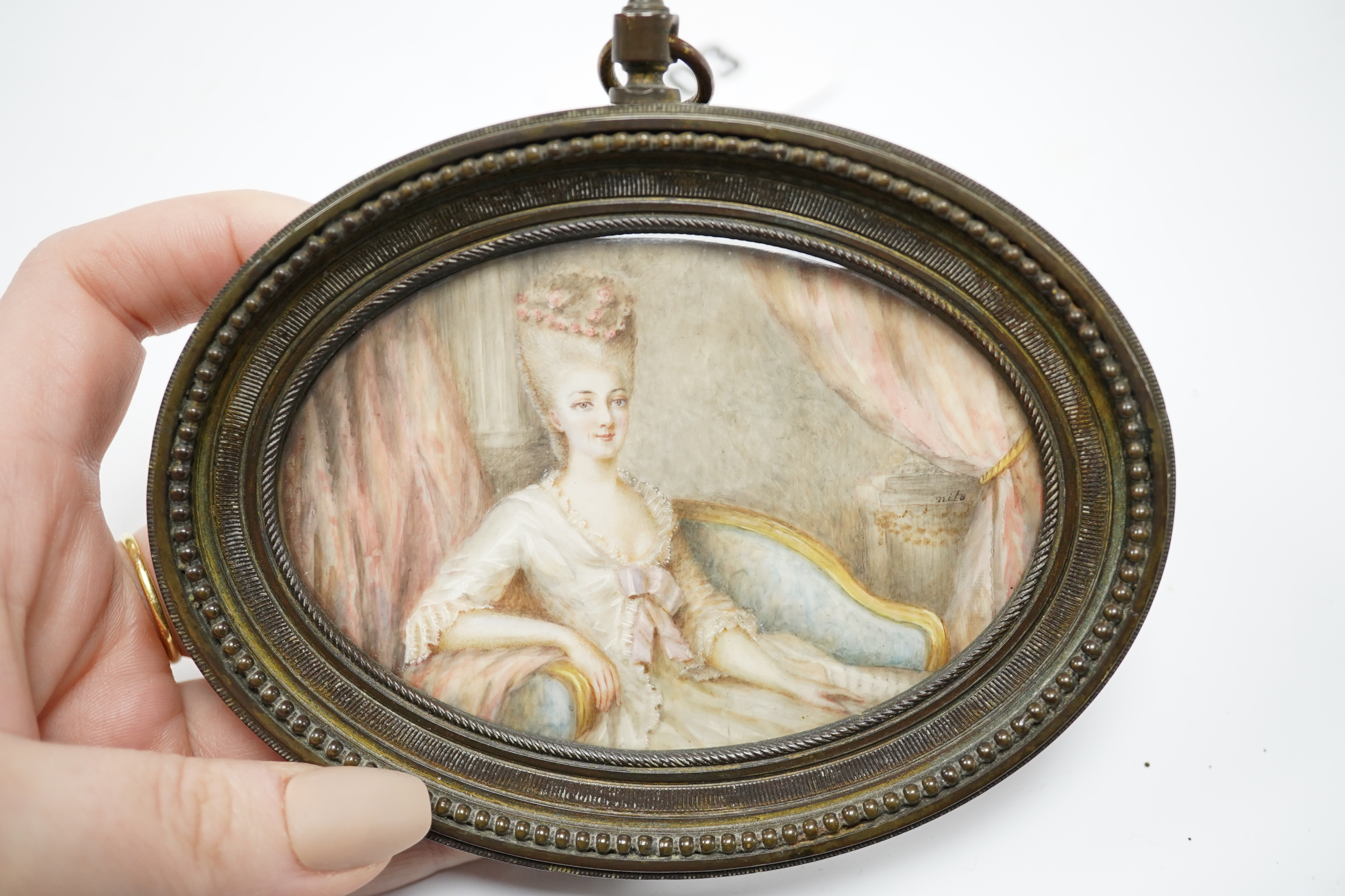 19th century, oval portrait miniature on ivory, signed nito, housed in a cast brass frame, overall 12 x 12.5cm. CITES Submission reference CR58C3KG. Condition - fair